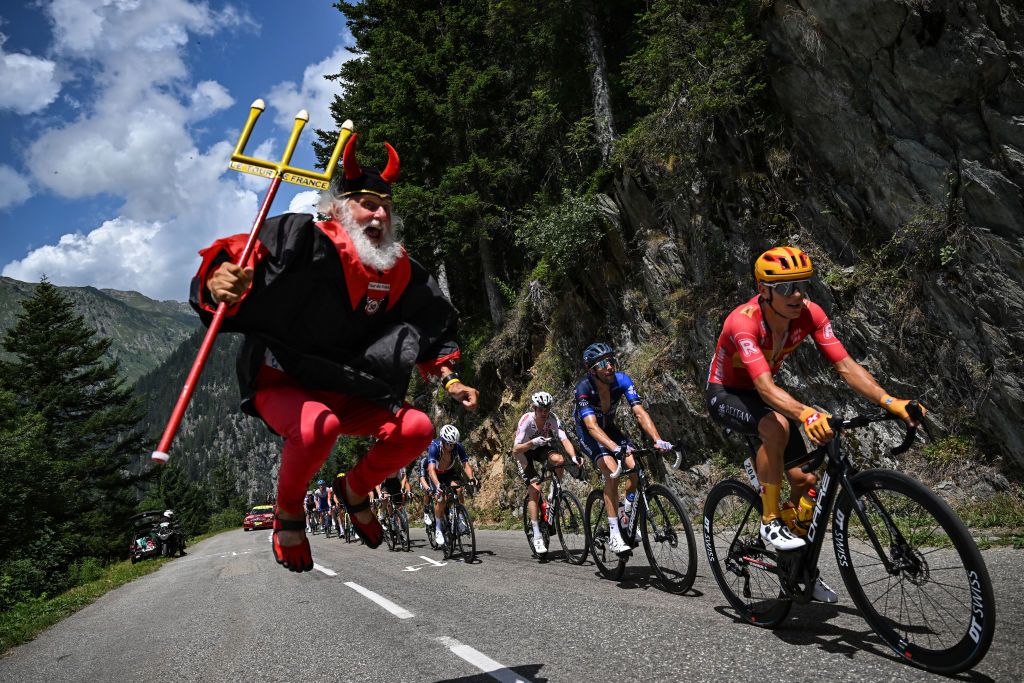 Uno-X Pro Cycling Team's Norwegian rider Tobias Halland Johannessen (R) and Groupama - FDJ's French rider Thibault Pinot (2nd R) cycle in a lead breakaway past cycling enthusiast better known as 'El Diablo' (The Devil), during the 17th stage of the 110th edition of the Tour de France cycling race, 166 km between Saint-Gervais Mont-Blanc and Courchevel, in the French Alps, on July 19, 2023. (Photo by Marco BERTORELLO / AFP)