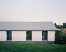 view of minimalist spanish house Casa Guadalupe by studio hanghar, a white house with dark timber accents