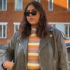 Woman wears distressed leather jacket