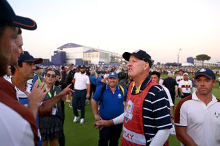 Joe LaCava speaks to members of the European team at the Ryder Cup