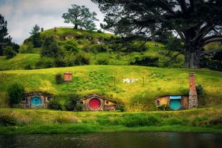 Colorful dugouts and pond at Hobbit village, New Zealand