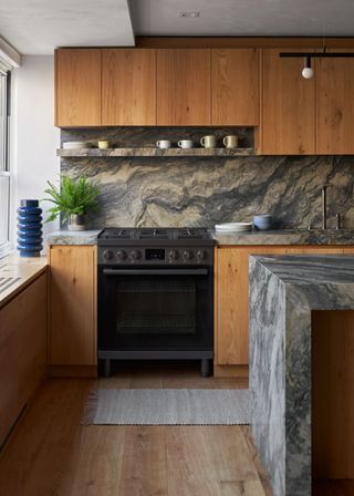 A kitchen with wood and marble accents