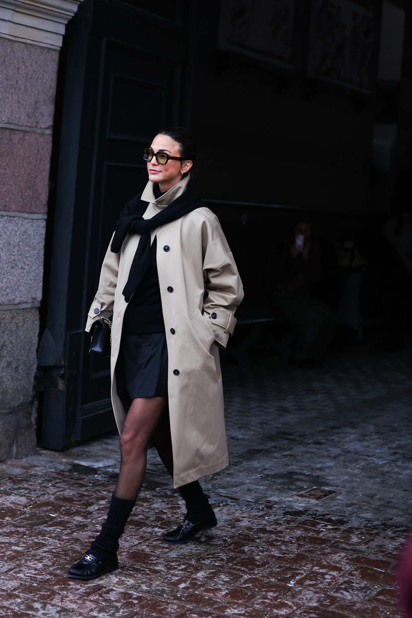 woman wearing trench coat, dress, and loafers