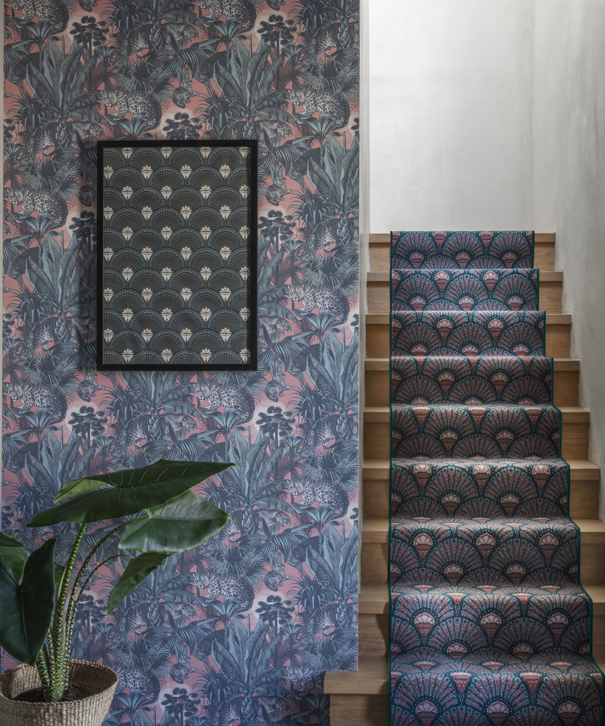 staircase with patterned stair runner and wallpaper in similar print