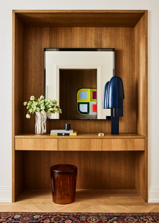 A wooden niche with a built-in table, located just inside the entrance