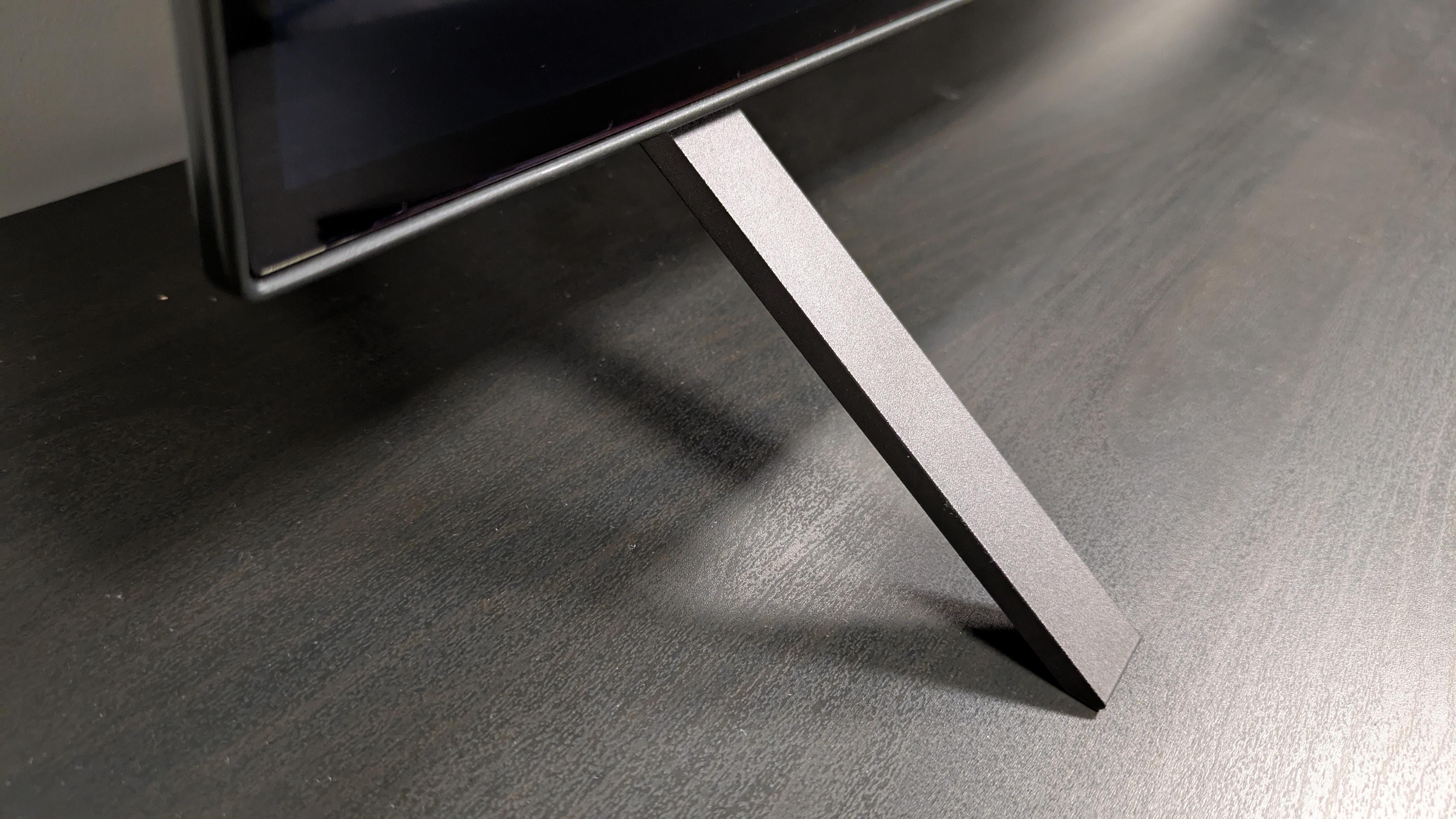 LG B5 OLED TV metal foot on dark surface