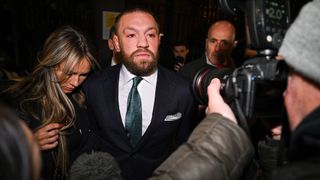 Dublin , Ireland - 22 November 2024; Mr Conor McGregor leaves court, accompanied by his partner Dee Devlin, after the court announced the jury's decision in the civil action case, P Ní Laimhin v McGregor & Anor, in High Court 24 at Chancery Place in Dublin. (Photo By David Fitzgerald/Sportsfile via Getty Images)