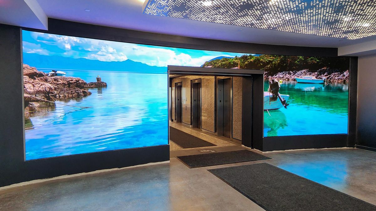 A lobby with an SNA Display showing the open sea crashing into the shore.