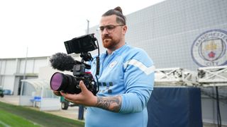 Lumix camera rig being operated by a Manchester City content team member in Man City shirt