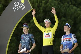 Tadej Pogačar on the podium with Jonas Vingegaard and Remco Evenepoel after the Tour de France 2024.