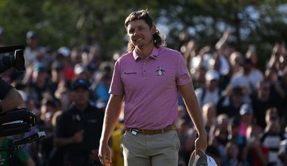 Cameron Smith smiles as he walks off the 18th green