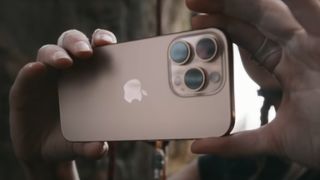 Two hands holding the iPhone 16 Pro showing its cameras