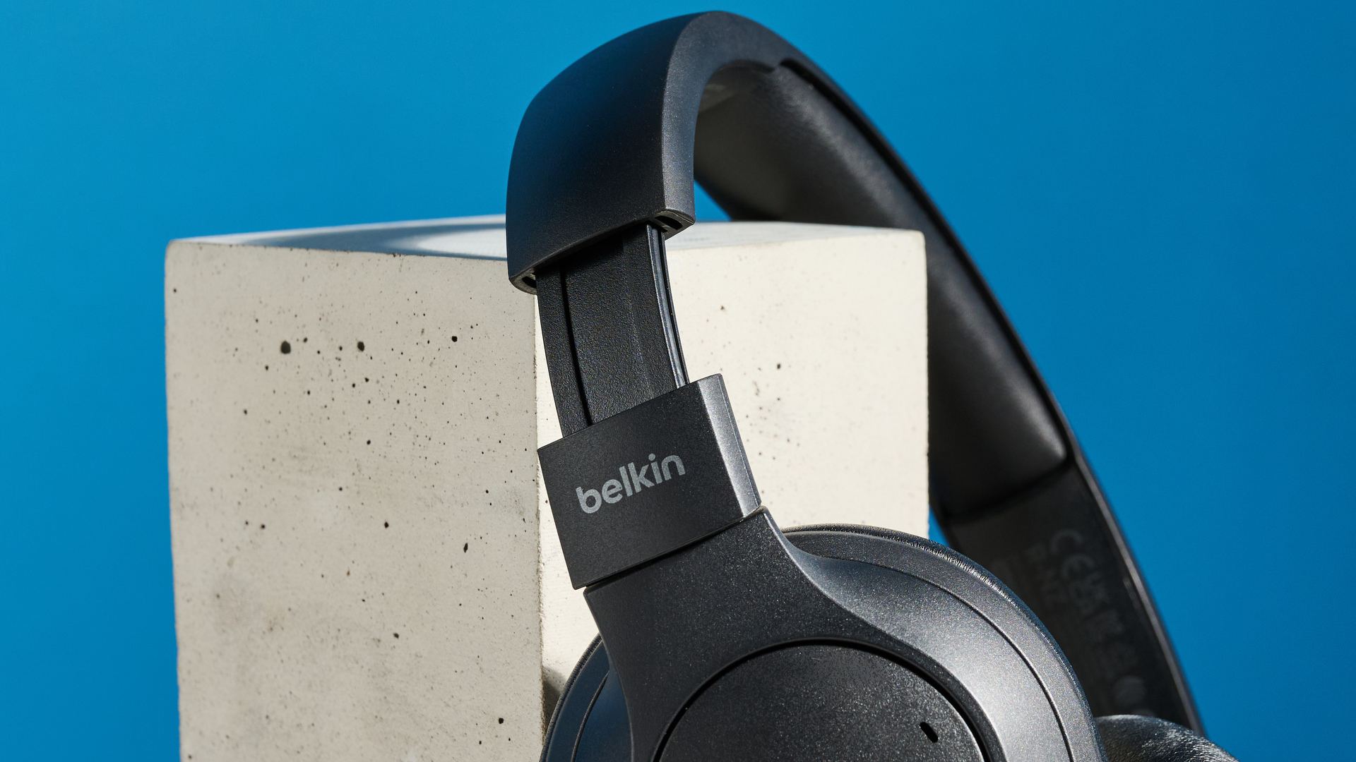 the belkin soundform isolate are a pair of budget headphones in black, with soft pillowy cups, control buttons on each cup, and ANC