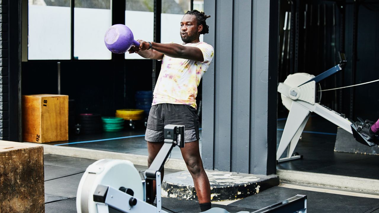 Man performing kettlebell swings