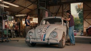 Lindsay Lohan and Justin Long standing next to a VW Bug in Herbie: Fully Loaded