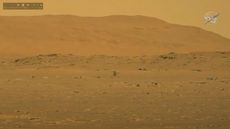 This still image from NASA's Perseverance rover on Mars shows the Mars Helicopter Ingenuity hovering above the Martian surface during its historic first flight on April 19, 2021. 