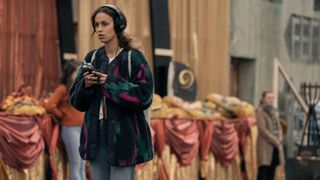 Emmy Sizergh (Robyn Cara) listening to her recording in the streets of Bodkin in Bodkin episode 5. 