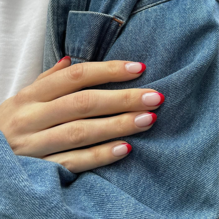 Red-tipped french manicure on almond nails