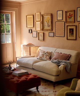 Plaster pink living room with linen sofa and gallery wall