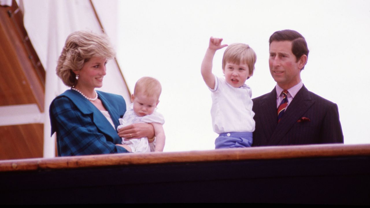 Diana Princess of Wales and Charles Prince of Wales hold Prince Harry and Prince William on the deck of the Royal Yacht Britannia