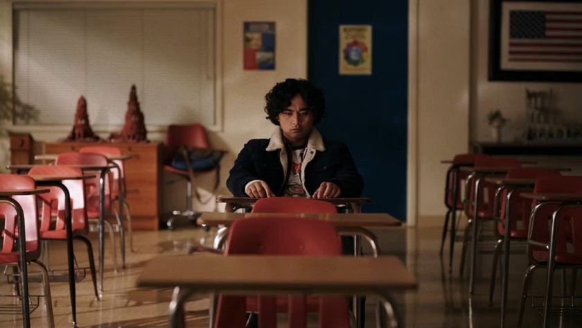 Kristian Ventura sitting in a classroom in School Spirits Season 3. 