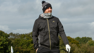 A golfer wears the adidas Rain.Rdy Hooded Jacket