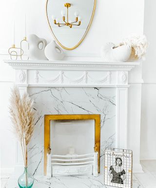 DIY fireplace with marble-effect vinyl and gold painted details