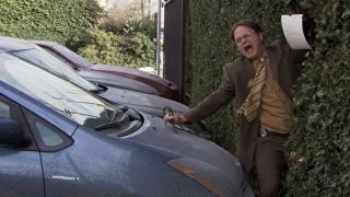 Dwight getting pushed by Andy's car in The Office