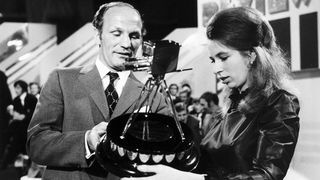 Princess Anne holds her Sports Personality of the Year award next to former British Heavyweight boxing champion Henry Cooper in 1971