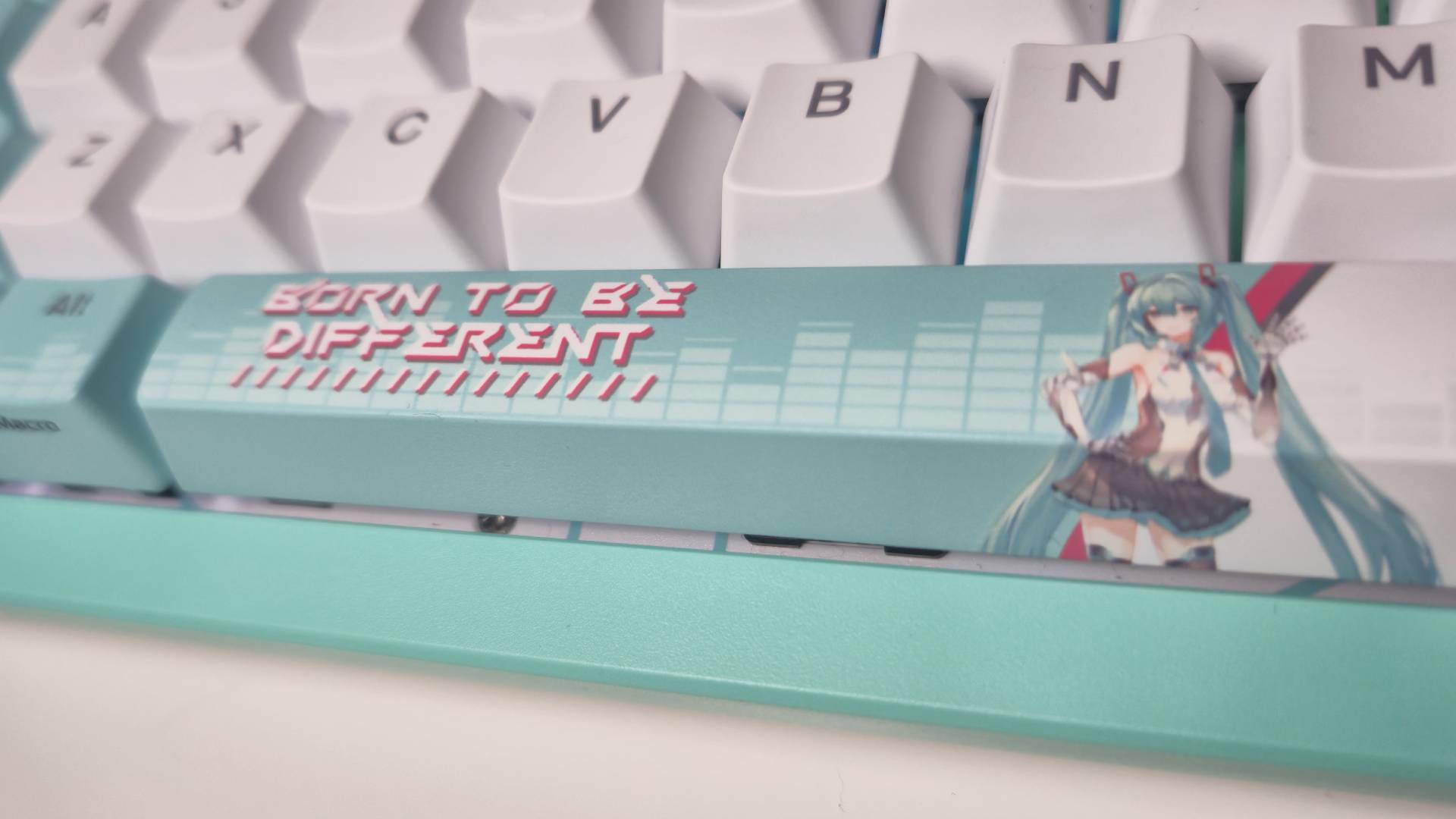 Photo by Rosalie Newcombe of the spacebar of the Asus TUF Gaming Hatsune Miku keyboard.