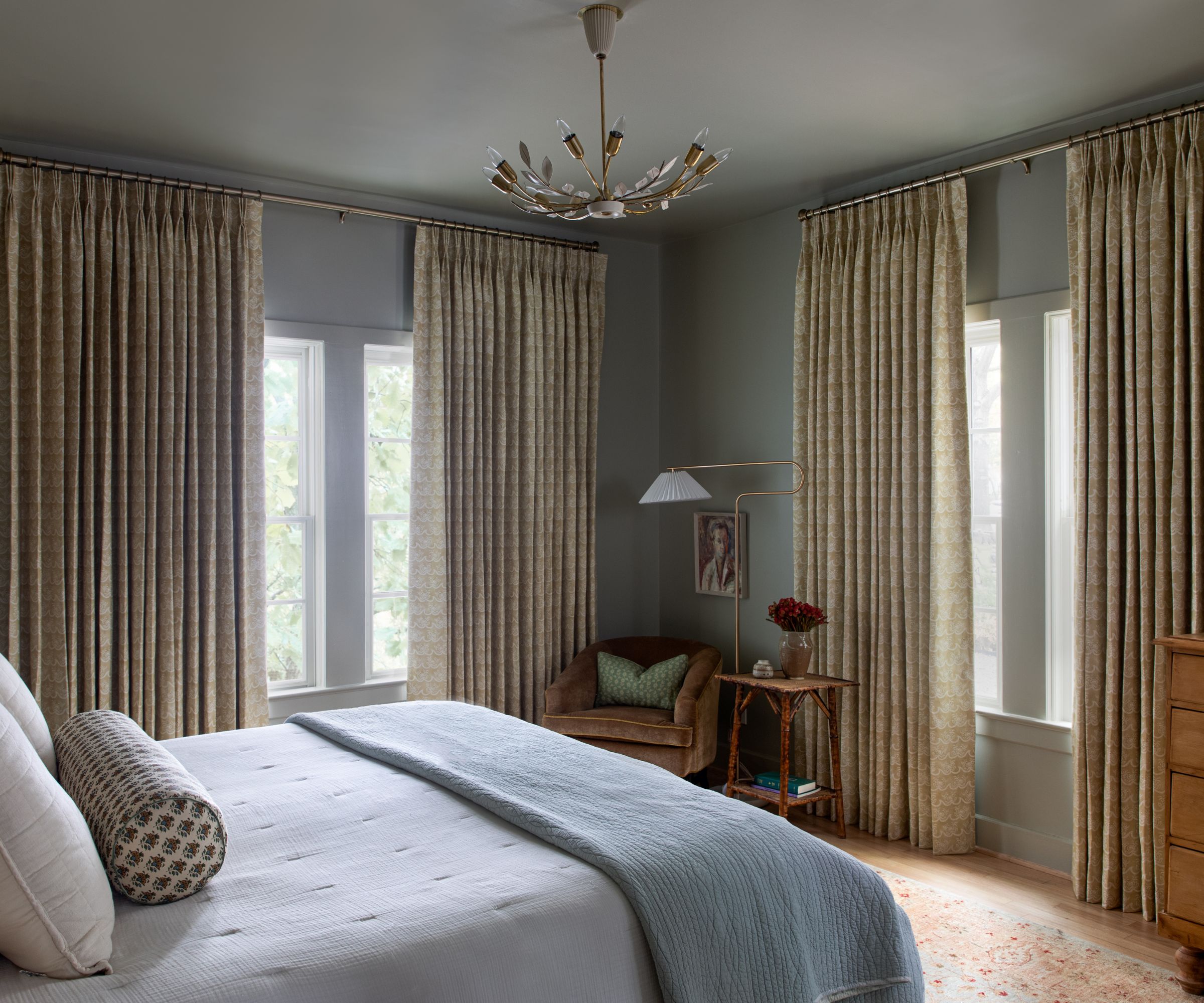 bedroom with gray walls, beige curtains and light blue bedding