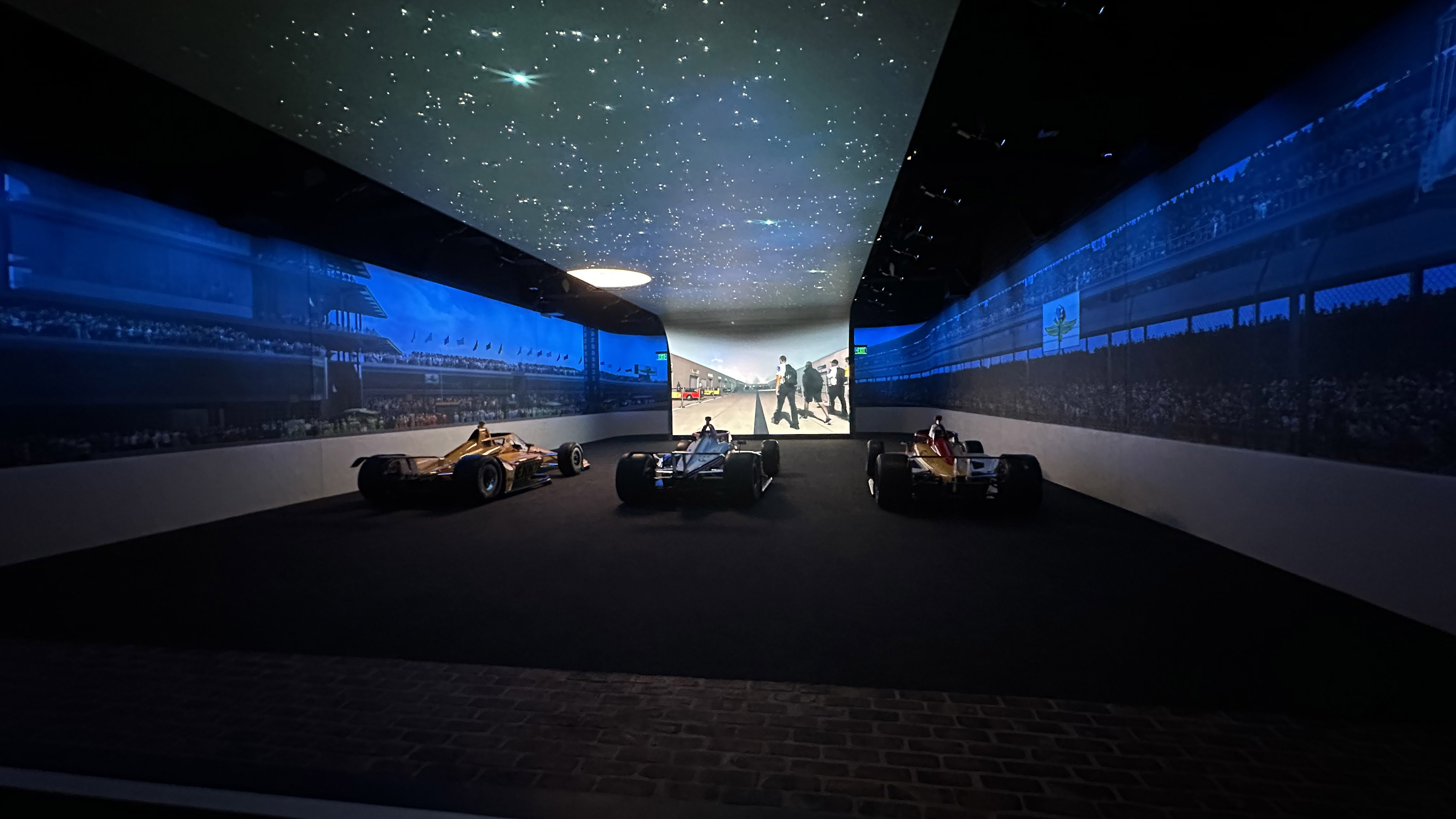 The Indianapolis Speedway Museum with an interactive racecar room surrounding cars with immersive displays. 