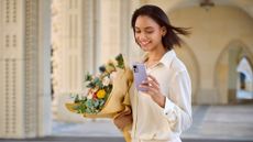 Xiaomi 12 review: woman holding a phone and flowers