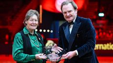 Jane Holderness-Roddam being presented with the British Equestrian Media Association (BEMA) Lifetime achievement awards by chairman Rupert Bell at the 2023 London International Horse Show.