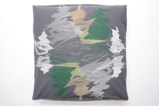 Grey cushion with green and grey scribble pattern