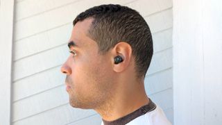 Our reviewer wearing the 1More PistonBuds Pro wireless earbuds