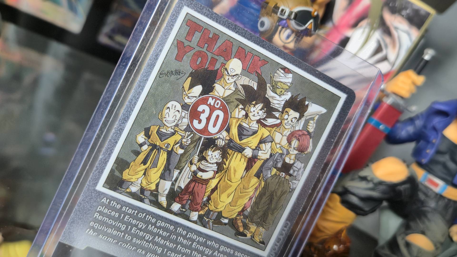 Photo by Rosalie Newcombe of a card from the Dragon Ball Super CG Fusion World - Manga Booster (SB01) box sitting in a display cabinet.