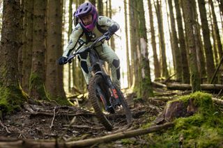 Rider on rooty trail with full face helmet on