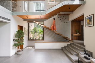 The Plumeria a concrete house engulfed in tropical foliage in India