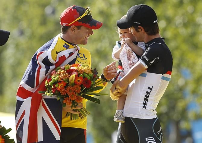 Cadel Evans and Frank Schleck share a moment on the podium of the 2011 Tour de France.