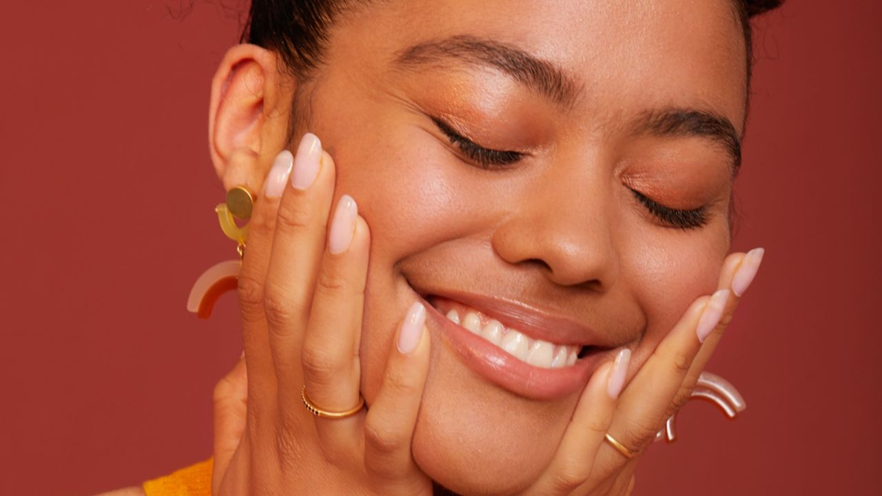 Women wearing makeup and smiling - stock photo