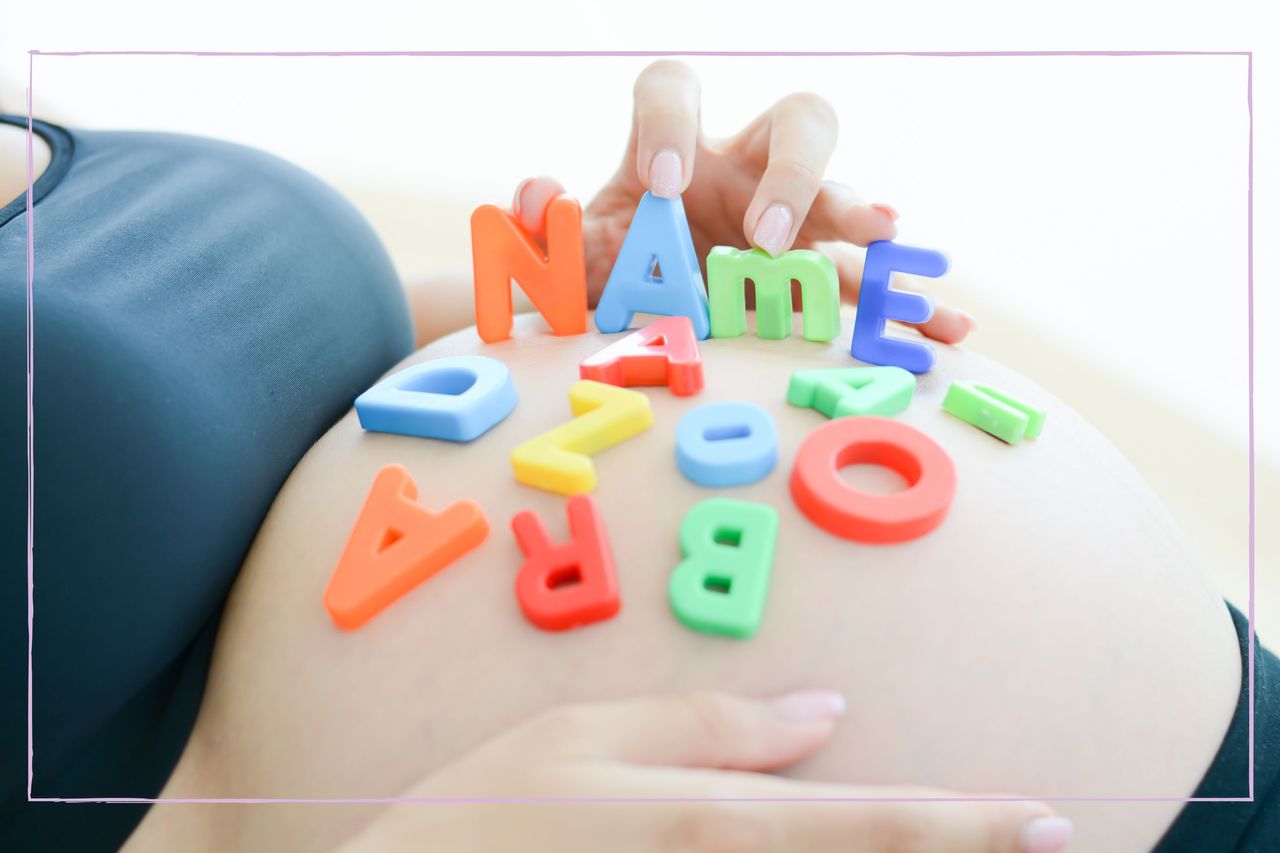 A pregnant stomach with magnetic letters on top spelling out &#039;name&#039;