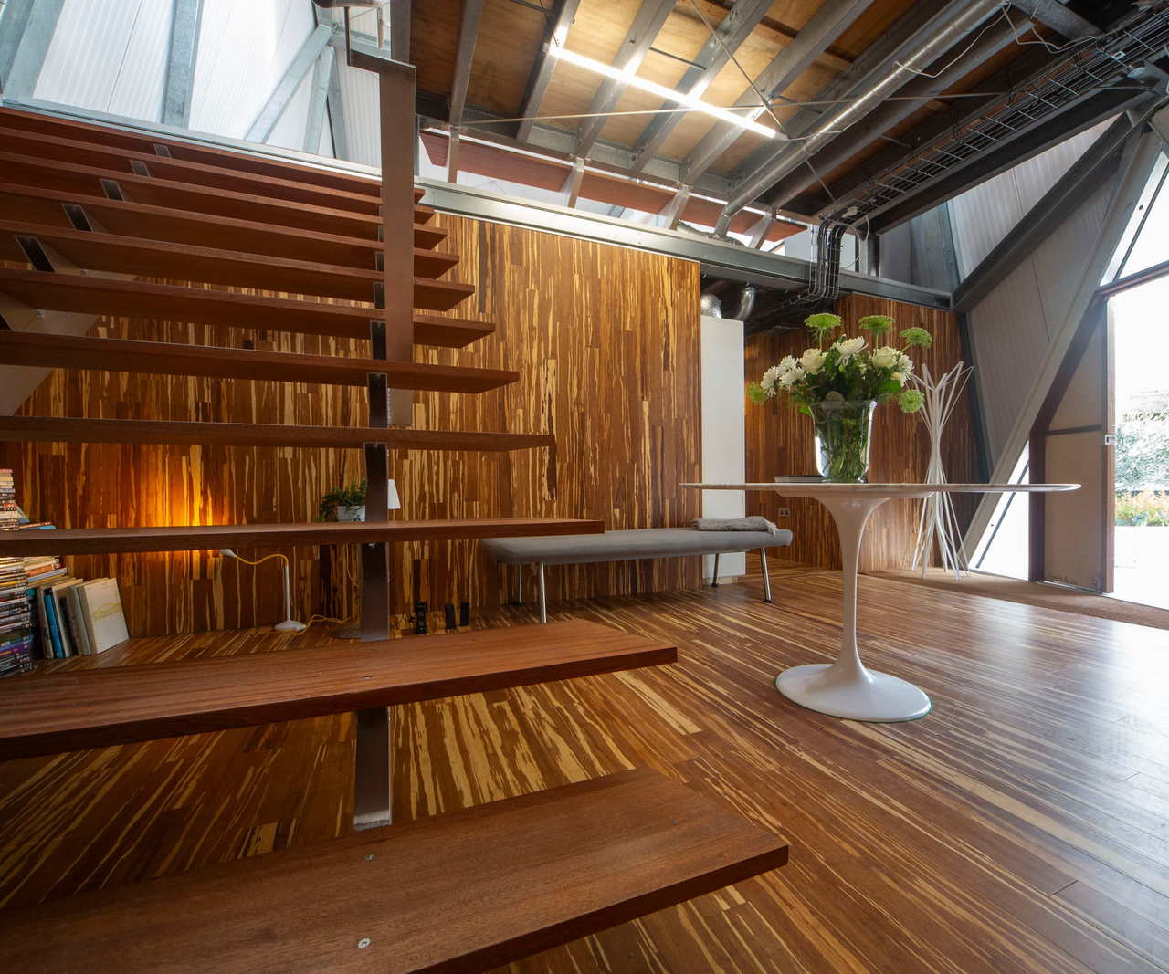 A wooden staircase with wooden flooring and a steel structure