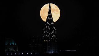 The full Hunter's Moon rises behind the Chrysler building in Manhattan, on Oct. 20, 2021.