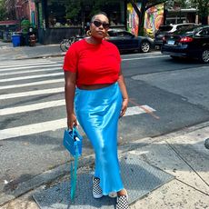 @aniyahmorinia wearin red t-shirt, cerulean skirt, and checkered vans