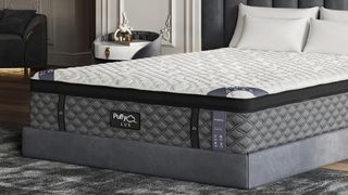 The Puffy Lux Mattress on a grey fabric bedframe