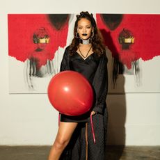 Rihanna holding a red balloon.