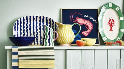 colorful patterned jugs and pictures on a sideboard