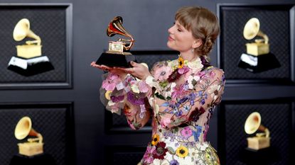 Taylor Swift with her Grammy on the red carpet at the 63rd Annual Grammy Awards, at the Los Angeles Convention Center, in downtown Los Angeles, CA, Sunday, Mar. 14, 2021. (Jay L. Clendenin / Los Angeles Times via Getty Images)