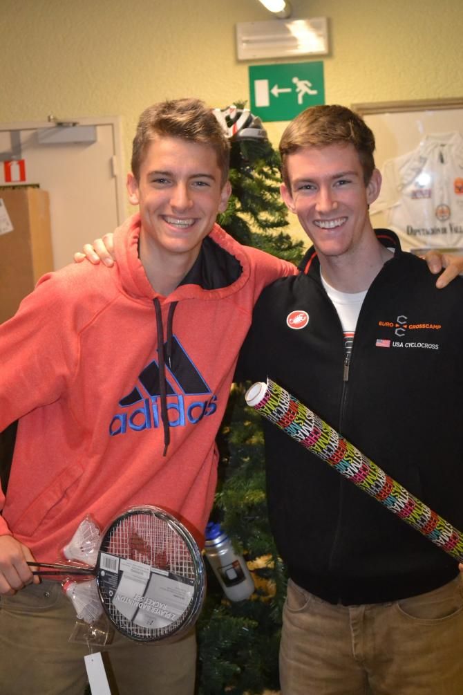 Drew Dillman celebrating Christmas with Gavin Haley during the EuroCrossCamp tradition of the white elephant gift exchange